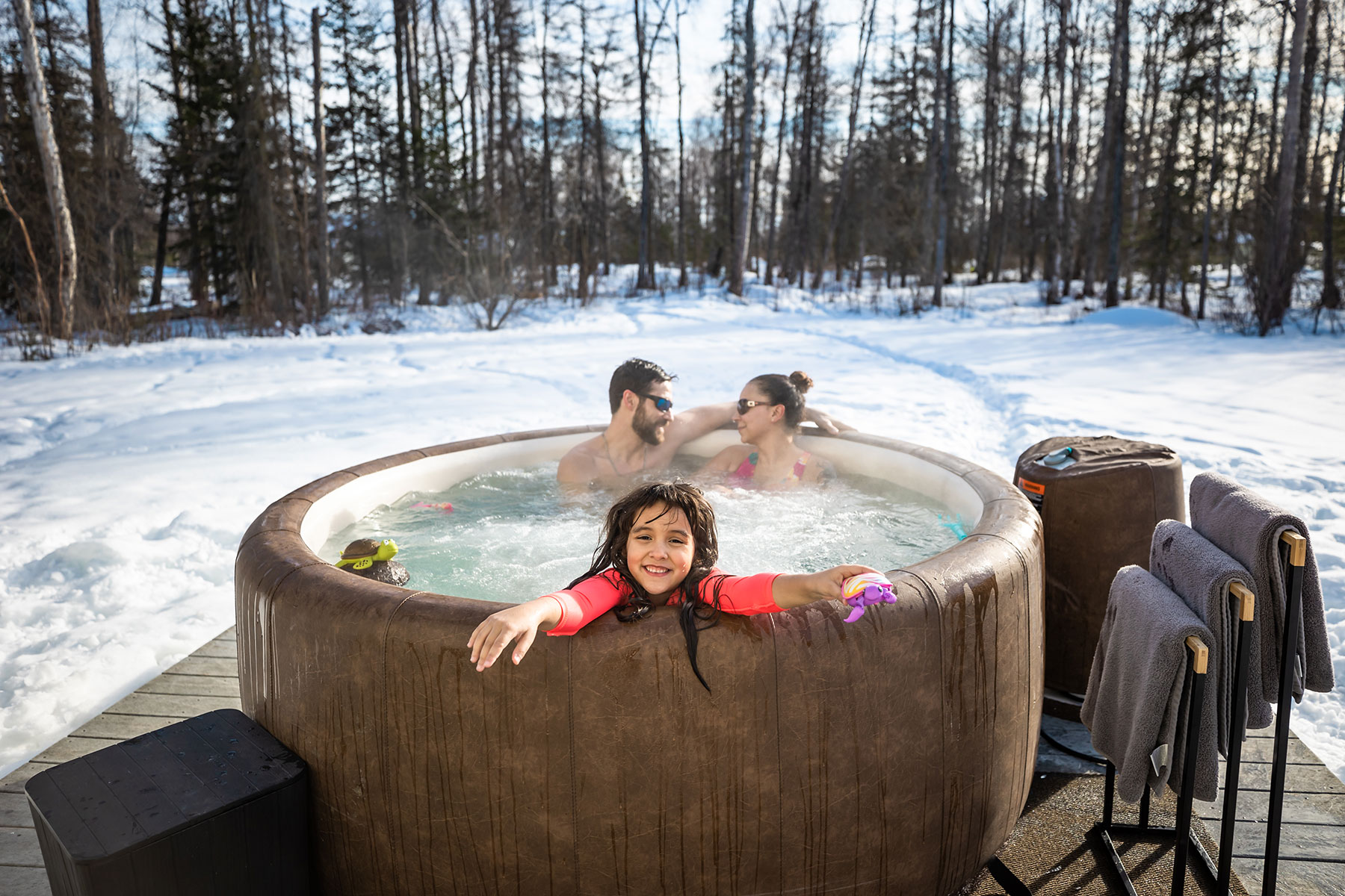 Happy family relaxes in Embers Alaska hot tub