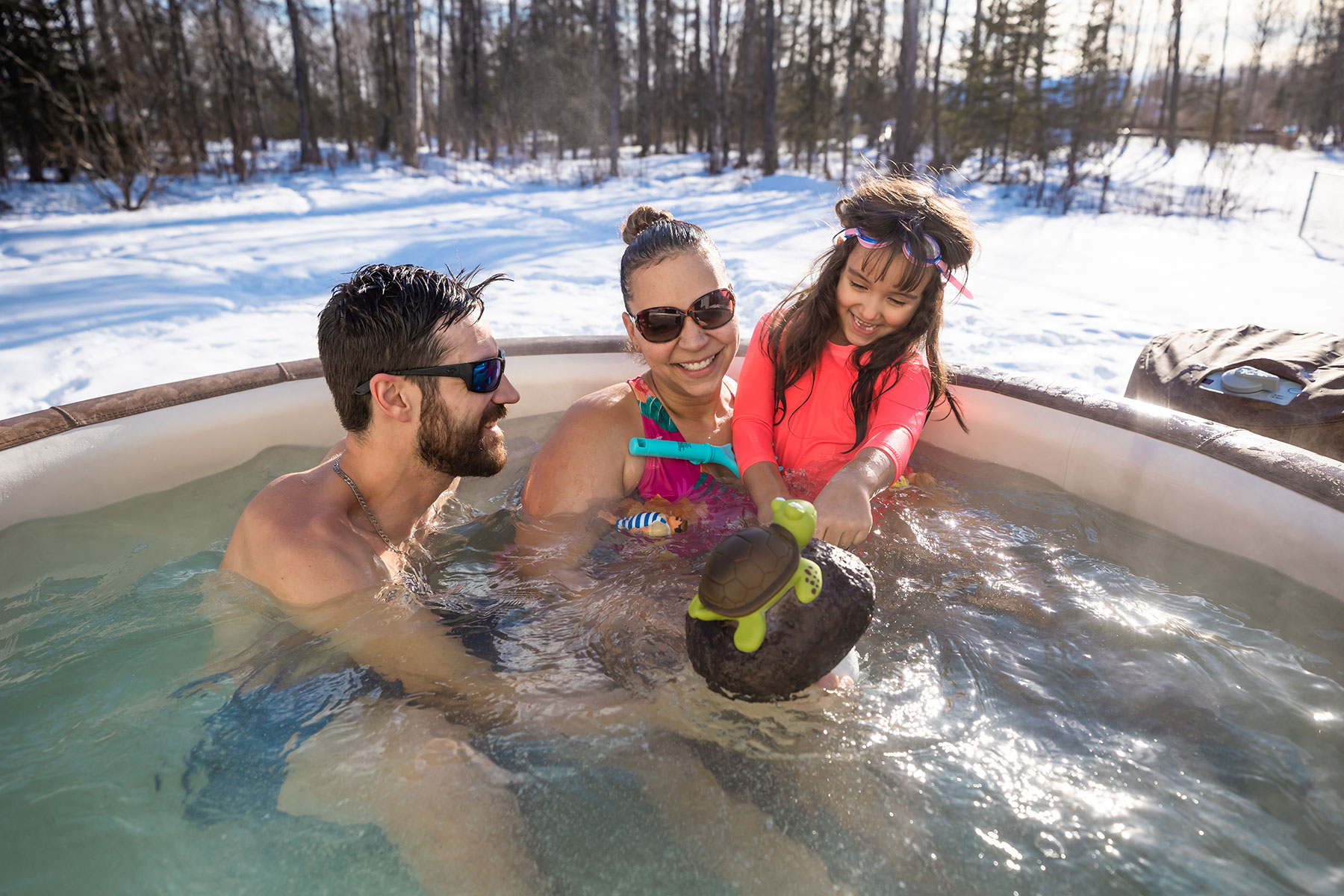 Family relaxes in Embers Alaska hot tub